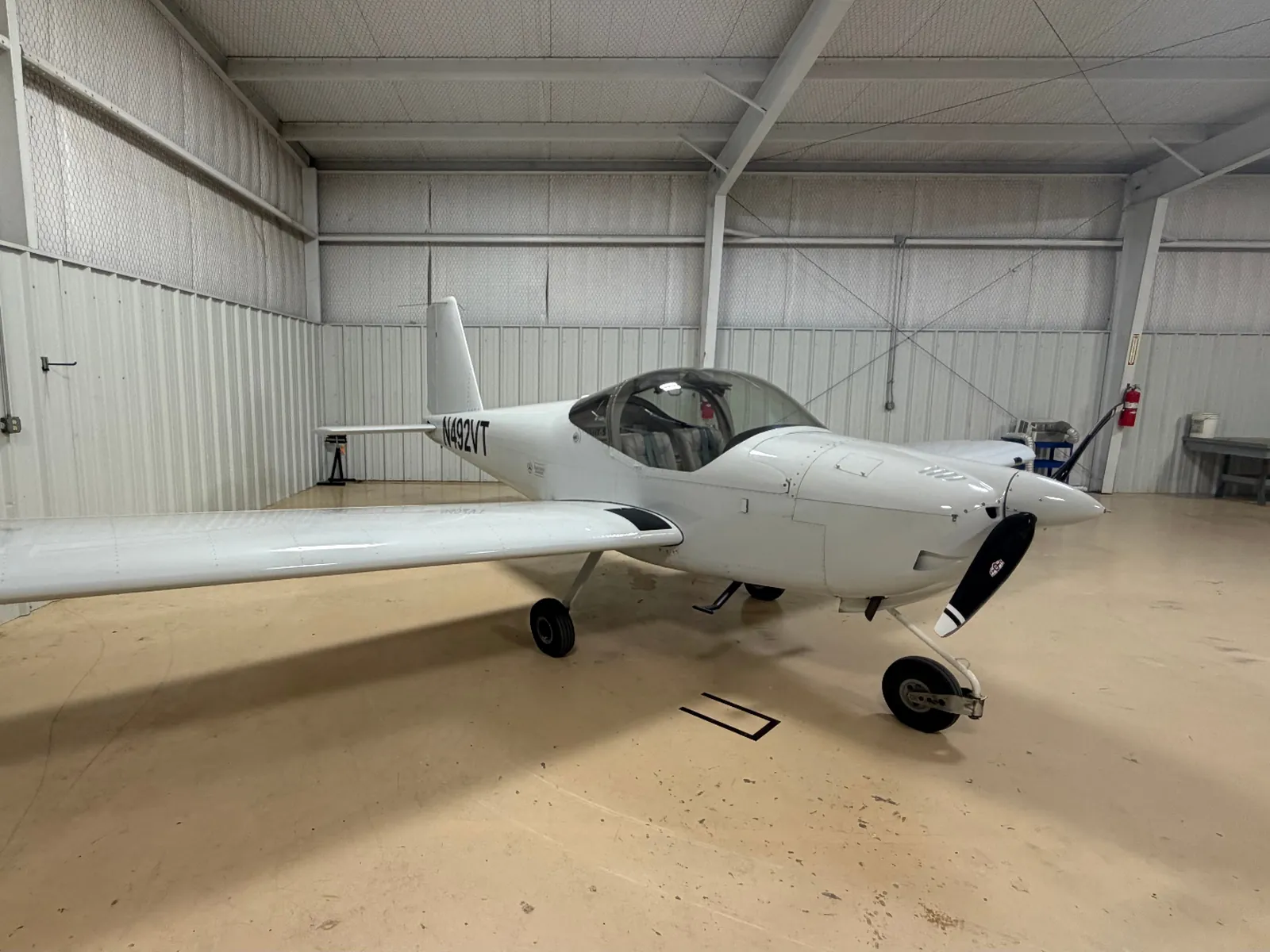 N492VT, a white Van's RV-12iS, parked inside a hangar