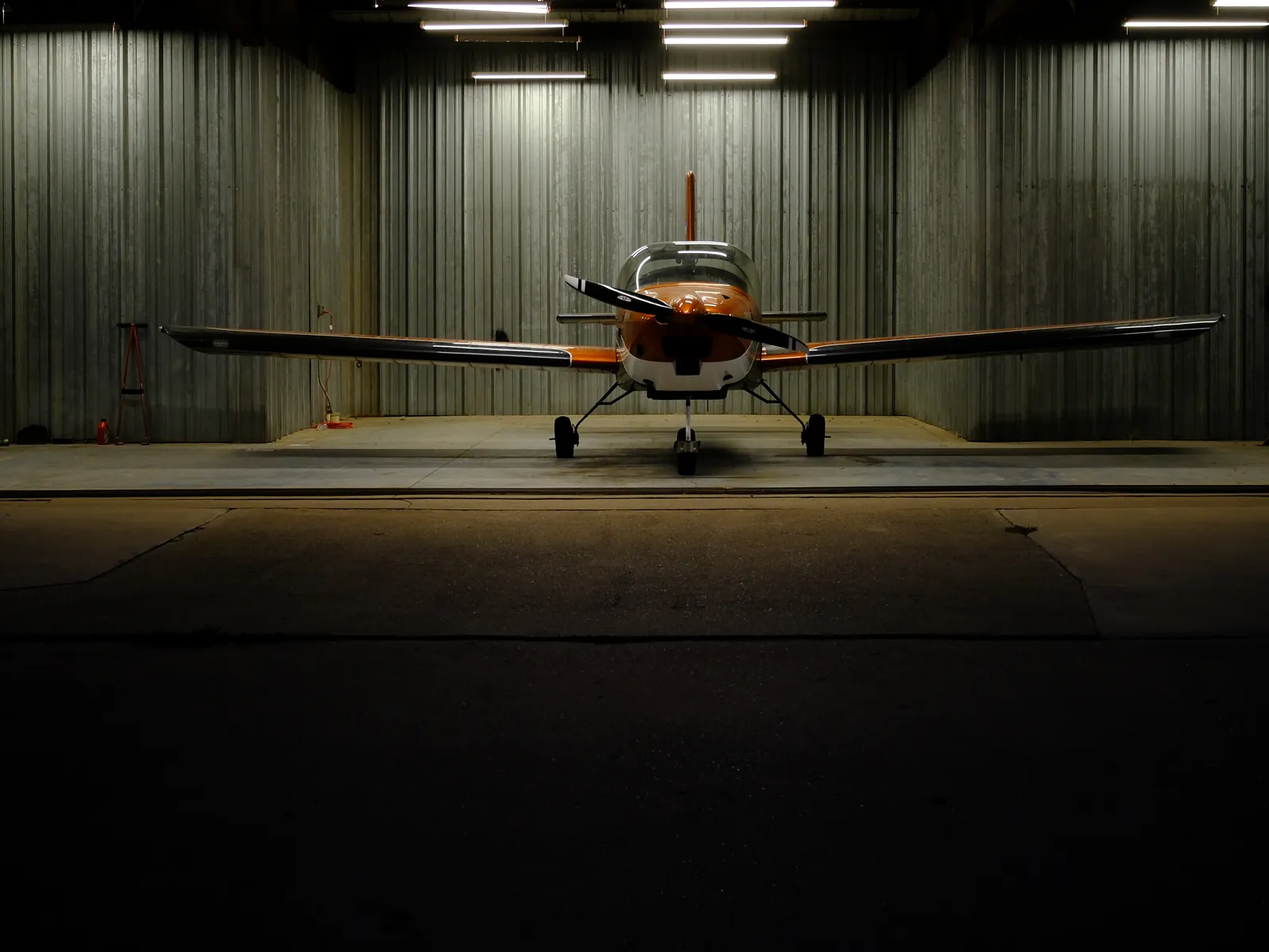 N812EJ seen head-on in the middle of an open hangar