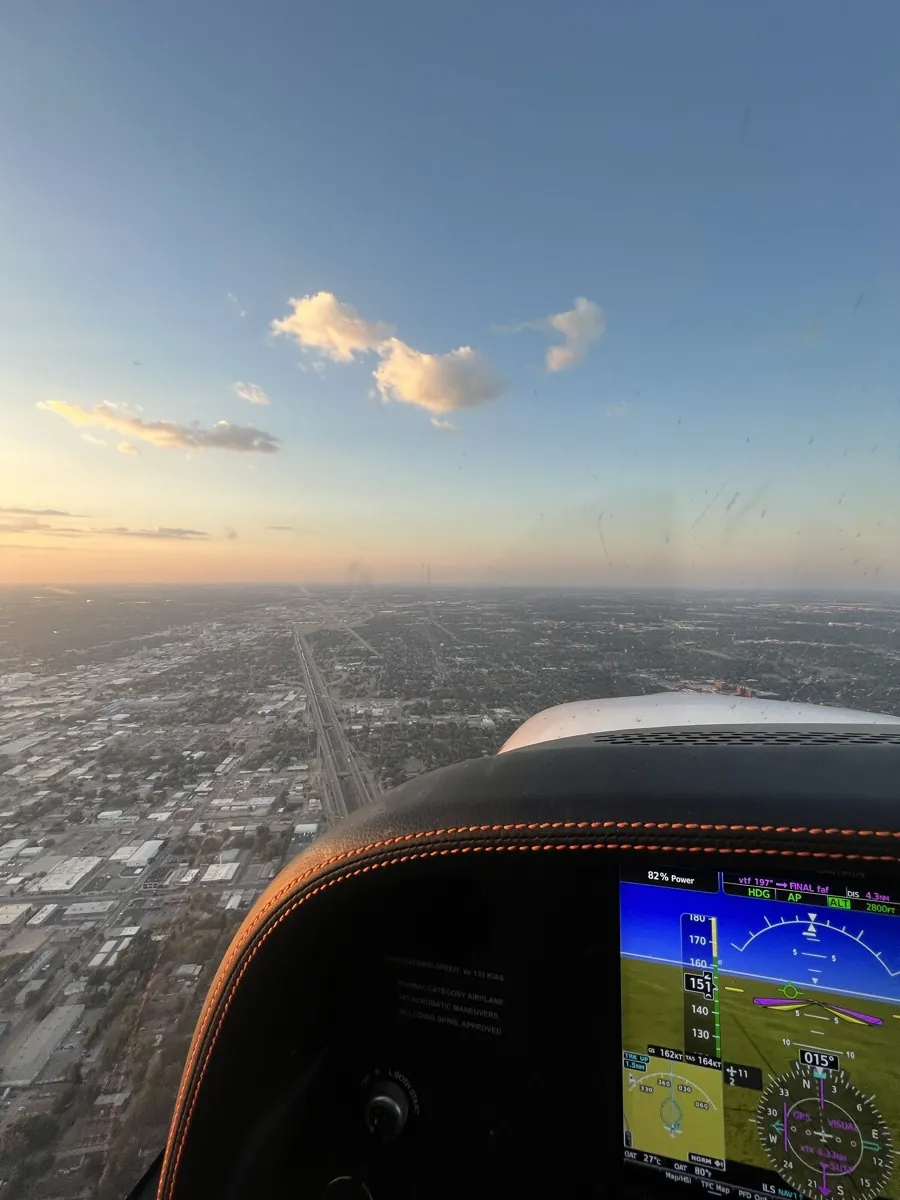 View over the city at sunset from the cockpit while flying