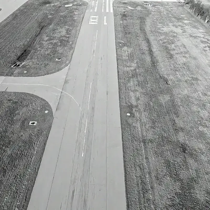 Looking down a runway centerline from the air, with the numbers painted at the threshold