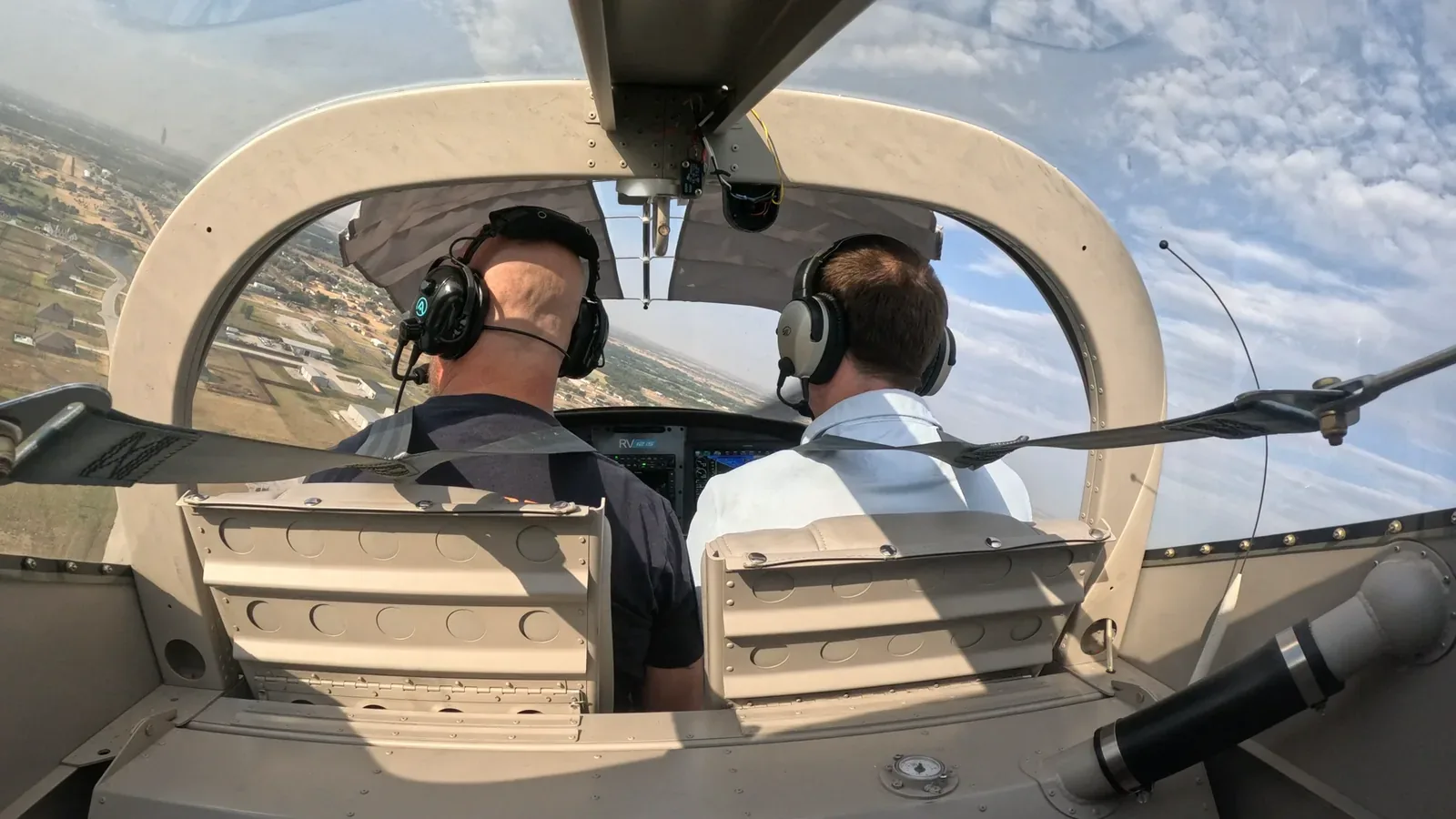 Instructor and student in the cockpit, headsets on, working through a lesson